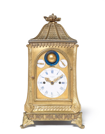 A large English brass quarter chiming skeleton clock with calendar
