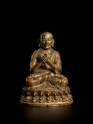 Bonhams : A GILT COPPER ALLOY FIGURE OF A LAMA TIBET, CIRCA 15TH CENTURY