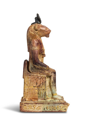 Bonhams : An Egyptian inlaid bichrome faience enthroned Bastet with ...