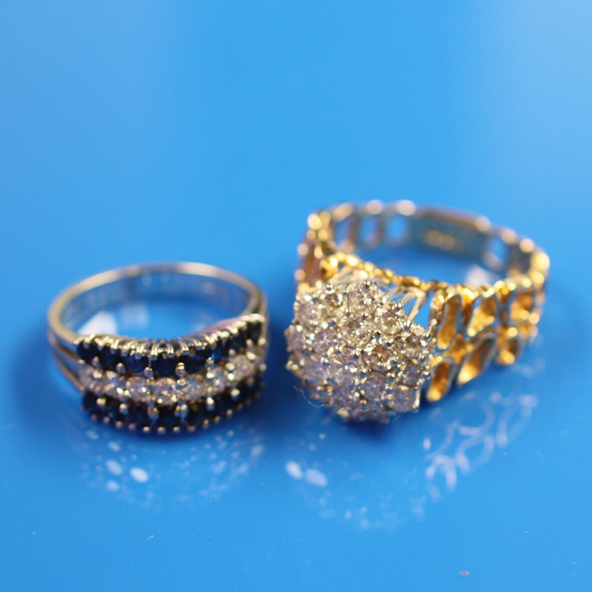 Bonhams : A diamond cluster ring and a sapphire and diamond ring (2)