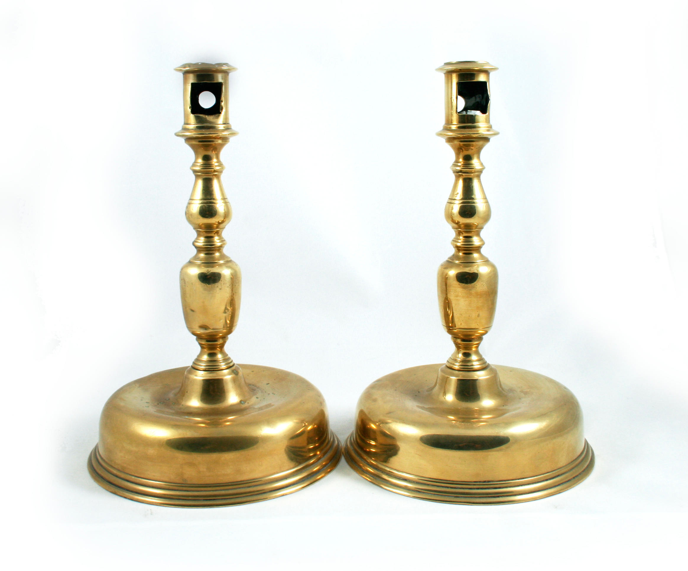 Bonhams : A pair of 17th century brass alloy pricket candlesticks