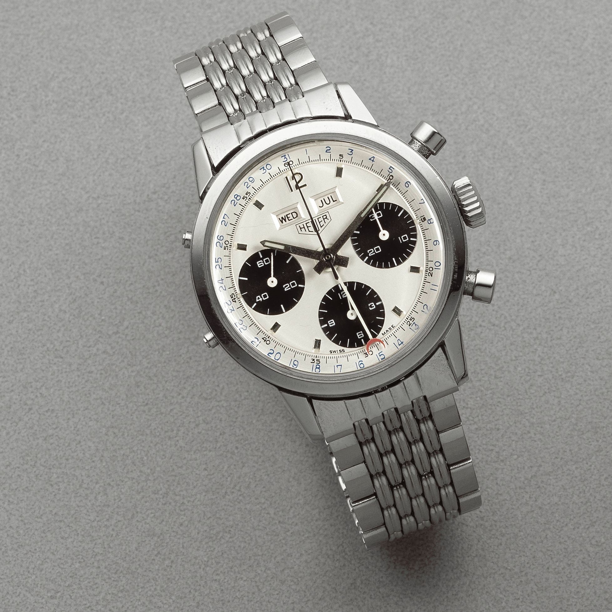 Bonhams A stainless steel manual wind triple calendar