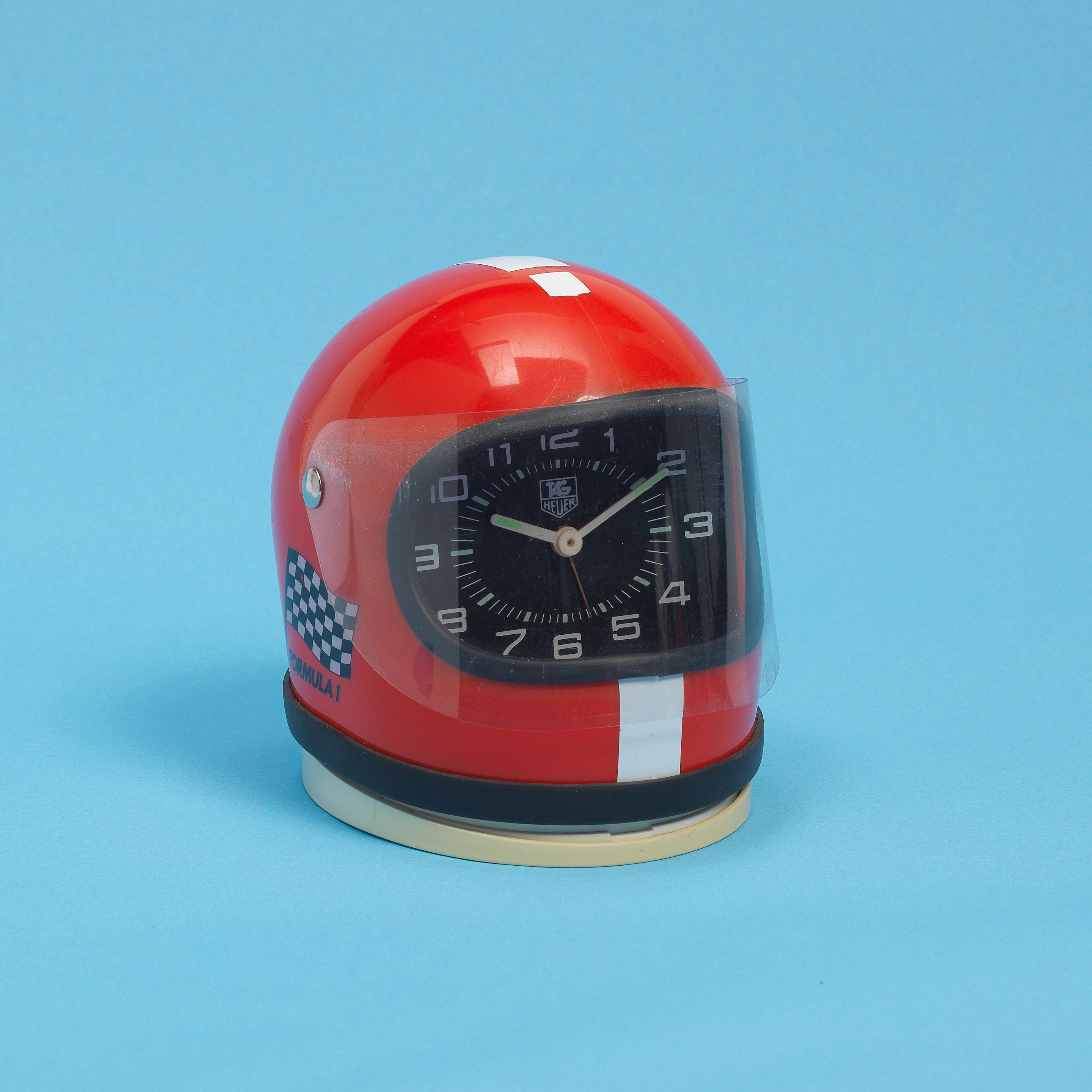 Bonhams : TAG Heuer. A miniature racing helmet desk clock with 