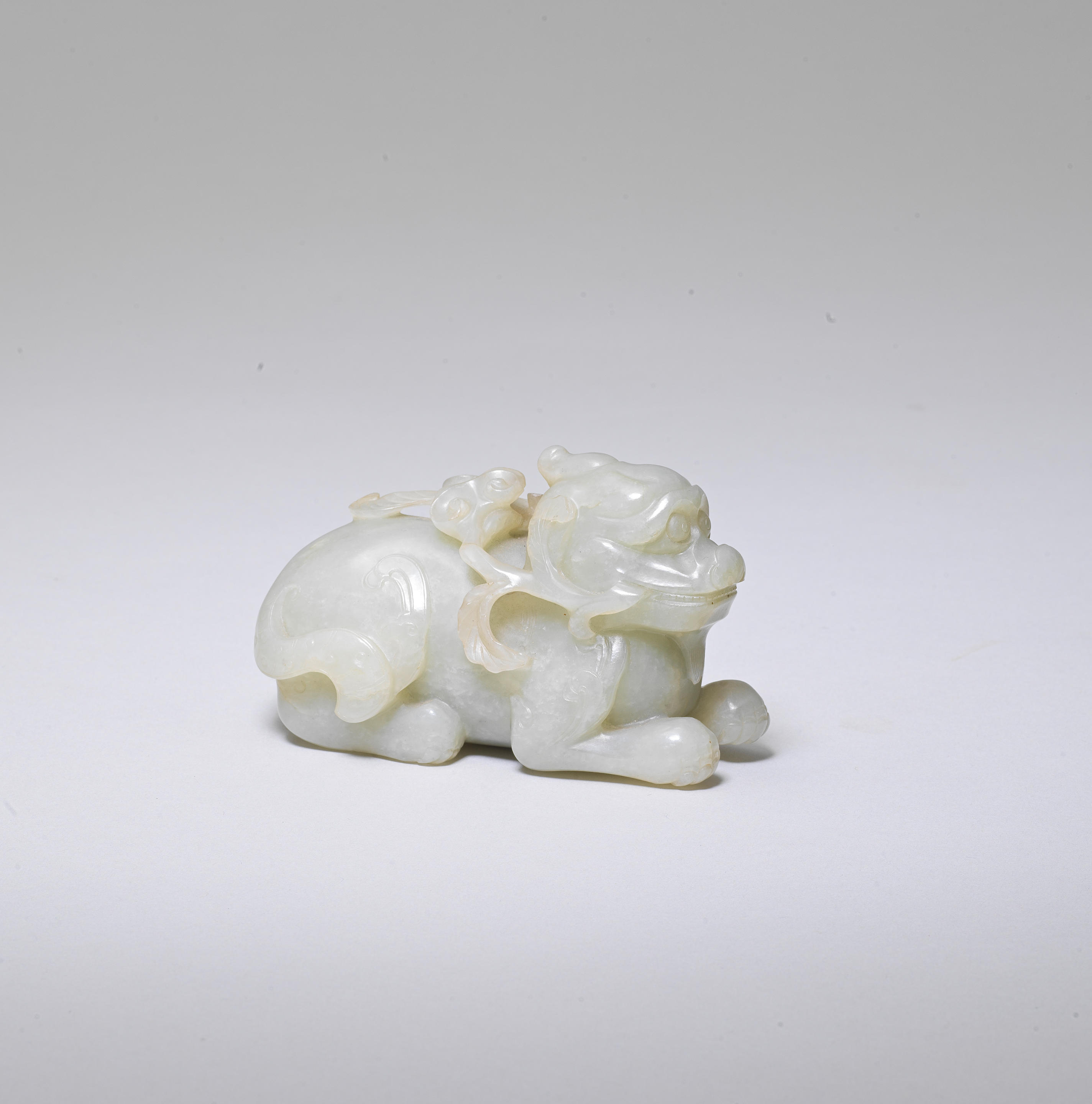 Bonhams : A PALE GREEN JADE CARVING OF A MYTHICAL BEAST 17th/18th century